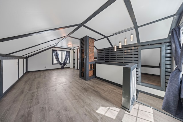 bonus room featuring wood finished floors and vaulted ceiling