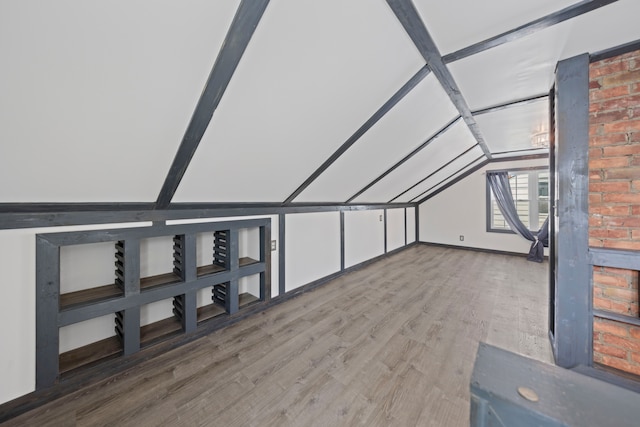 bonus room with vaulted ceiling and wood finished floors