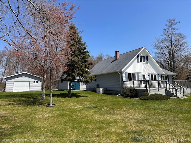 2800 E Booth Rd, Au Gres, MI 48703 - view of property exterior featuring a garage, an outbuilding, a yard, a wooden deck, and a chimney