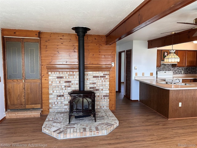 2800 E Booth Rd, Au Gres, MI 48703 - living area with a wood stove, wood finished floors, a textured ceiling, wooden walls, and ceiling fan