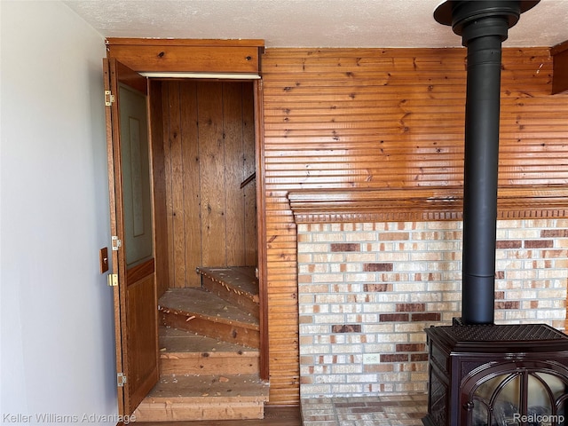 2800 E Booth Rd, Au Gres, MI 48703 - stairs featuring a wood stove and wood walls