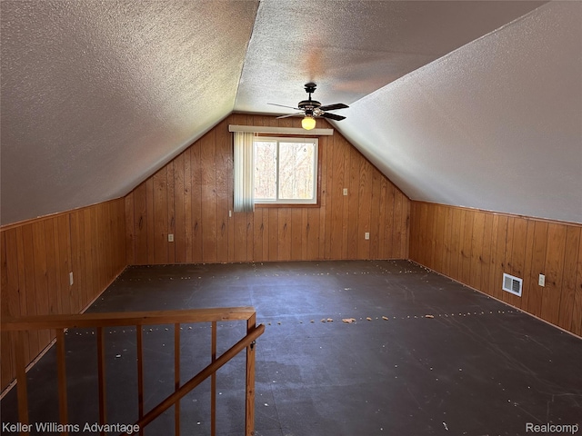 2800 E Booth Rd, Au Gres, MI 48703 - additional living space featuring wood walls, lofted ceiling, ceiling fan, and a textured ceiling