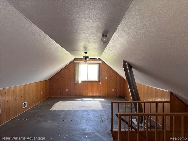 2800 E Booth Rd, Au Gres, MI 48703 - additional living space featuring wood walls, a textured ceiling, and lofted ceiling