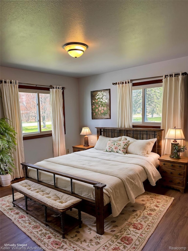 2800 E Booth Rd, Au Gres, MI 48703 - bedroom featuring wood finished floors and a textured ceiling