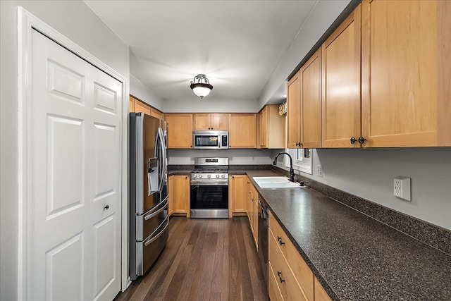 25455 Buckminster Dr, Novi, MI 48375 - kitchen with appliances with stainless steel finishes, a sink, dark countertops, and dark wood finished floors