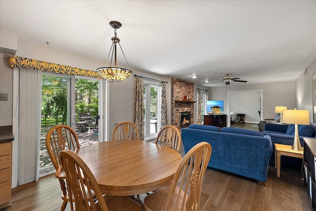 25455 Buckminster Dr, Novi, MI 48375 - dining area with wood-type flooring, ceiling fan, and a fireplace