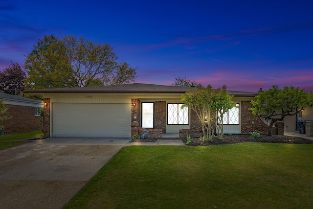 13488 Kingsville Dr, Sterling Heights, MI 48312 - view of front facade with brick siding, an attached garage, a lawn, and concrete driveway