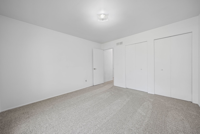 13488 Kingsville Dr, Sterling Heights, MI 48312 - unfurnished bedroom with multiple closets and carpet flooring