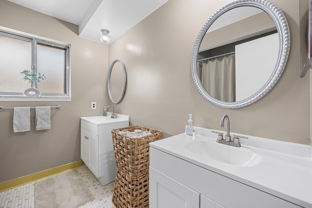 13488 Kingsville Dr, Sterling Heights, MI 48312 - bathroom with two vanities, baseboards, and tile patterned floors