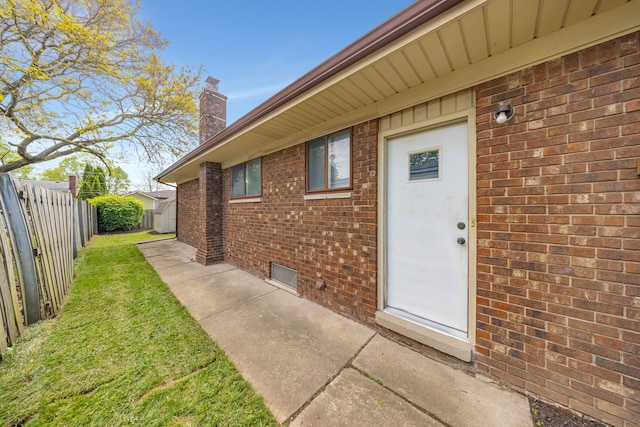 13488 Kingsville Dr, Sterling Heights, MI 48312 - view of exterior entry with brick siding and a chimney