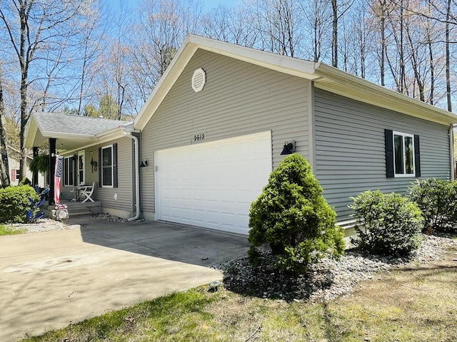9612 Clubhouse Dr W, Canadian Lakes, MI 49346 - view of side of property with a porch, an attached garage, and concrete driveway