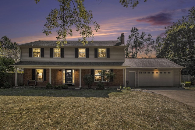 2021 Skyler Dr, Kalamazoo, MI 49008 - view of front of property with a chimney, a garage, driveway, and brick siding
