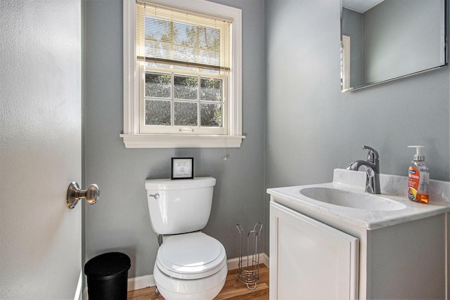 2021 Skyler Dr, Kalamazoo, MI 49008 - half bathroom with wood finished floors, toilet, baseboards, and vanity