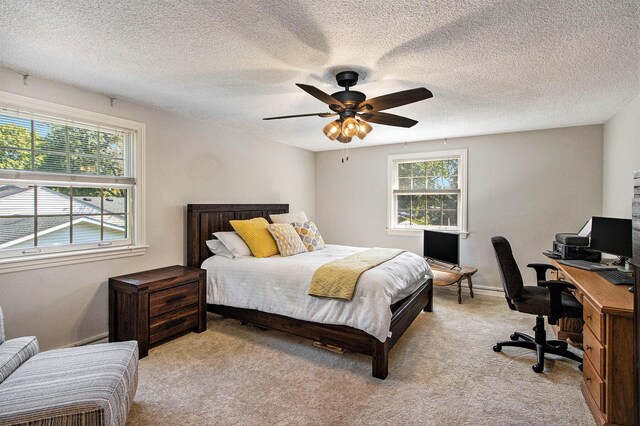 2021 Skyler Dr, Kalamazoo, MI 49008 - bedroom featuring an office area, light carpet, ceiling fan, and a textured ceiling