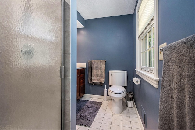 2021 Skyler Dr, Kalamazoo, MI 49008 - bathroom with tile patterned flooring, a shower stall, toilet, vanity, and baseboards