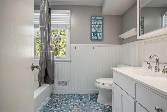 2021 Skyler Dr, Kalamazoo, MI 49008 - full bath with toilet, vanity, a wainscoted wall, shower / bath combo, and tile patterned floors