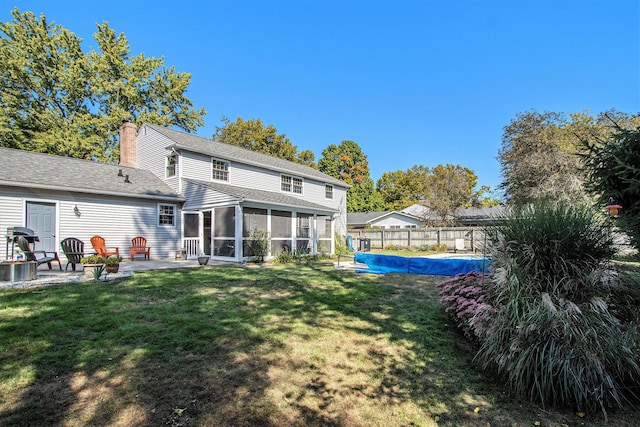 2021 Skyler Dr, Kalamazoo, MI 49008 - rear view of property with a sunroom, a patio area, a chimney, and roof with shingles