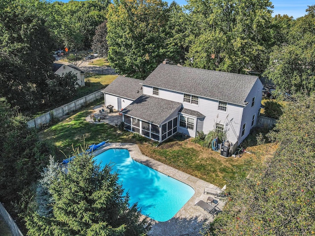 2021 Skyler Dr, Kalamazoo, MI 49008 - view of swimming pool with a sunroom and a patio