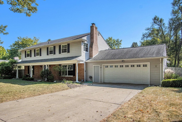 2021 Skyler Dr, Kalamazoo, MI 49008 - view of front of home with a garage, a chimney, a front yard, driveway, and brick siding