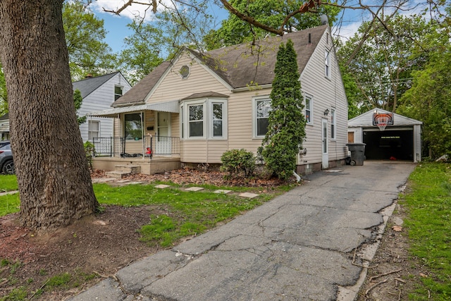 view of front facade featuring covered porch, an outdoor structure, a garage, and roof with shingles