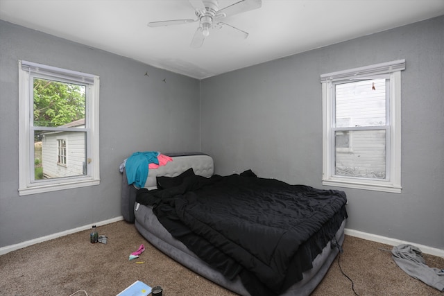 carpeted bedroom with baseboards and a ceiling fan
