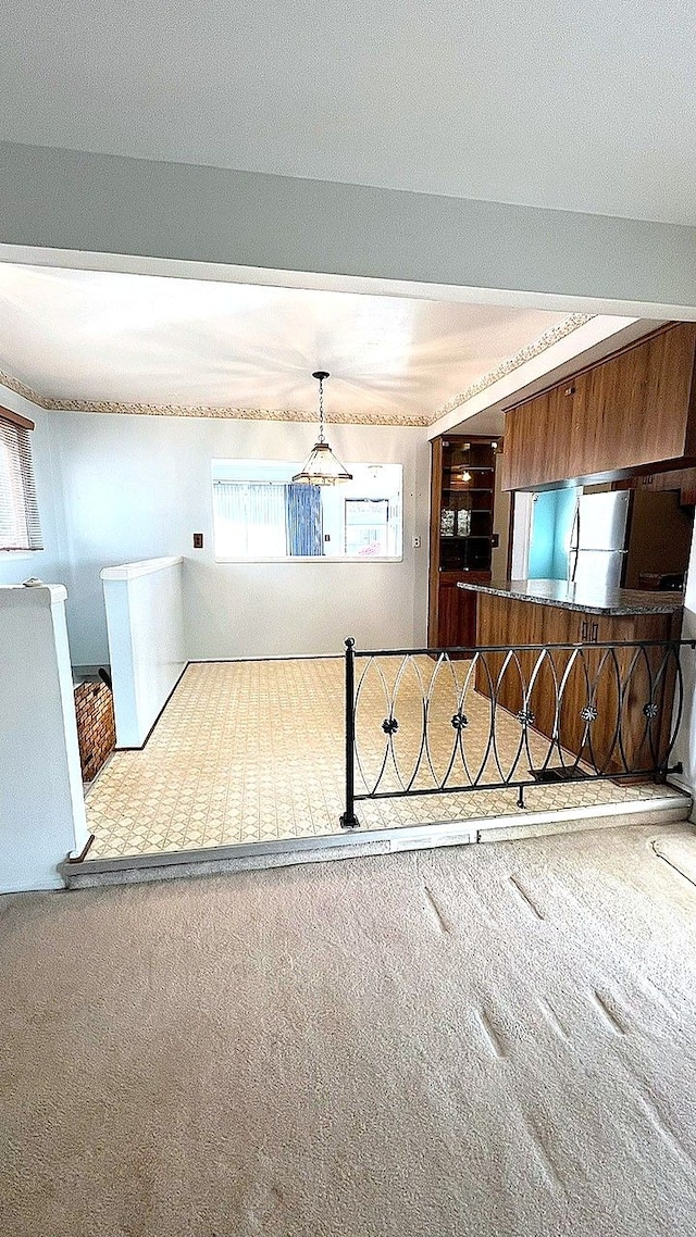 unfurnished living room featuring carpet flooring
