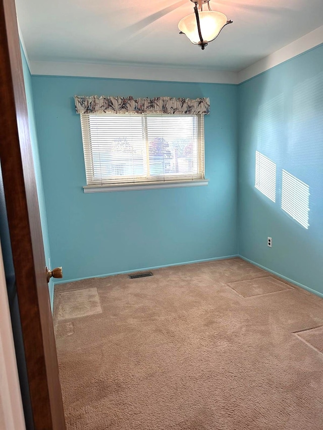 unfurnished room with carpet flooring, crown molding, and baseboards