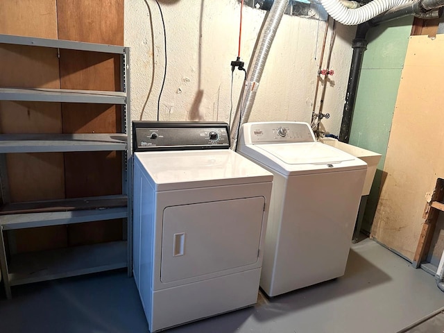 clothes washing area with washer and clothes dryer