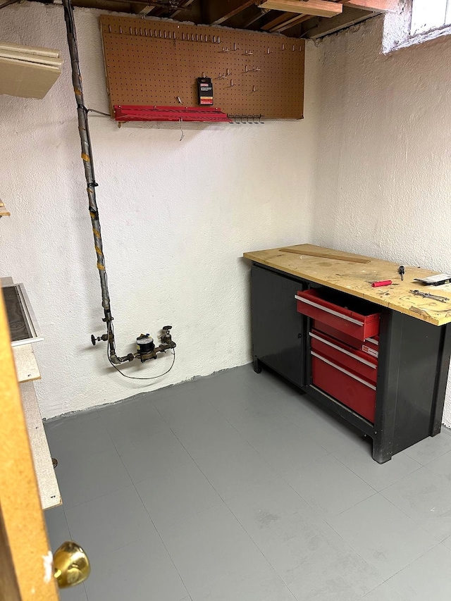 unfinished below grade area with a workshop area