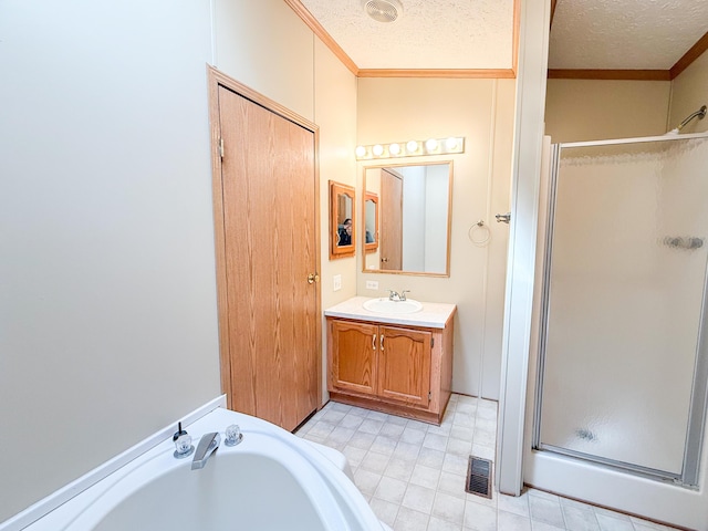 full bath featuring crown molding, a shower stall, a textured ceiling, a bath, and vanity