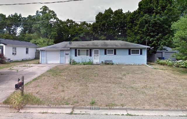 8830 Balmoral St, Portage, MI 49002 - single story home with concrete driveway, an attached garage, and a front yard