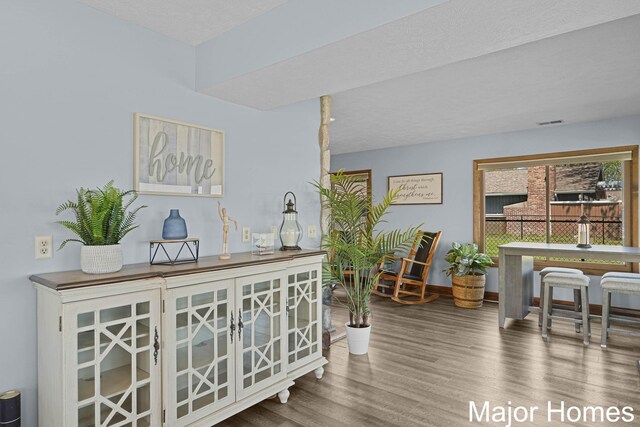 bar area with wood finished floors and baseboards