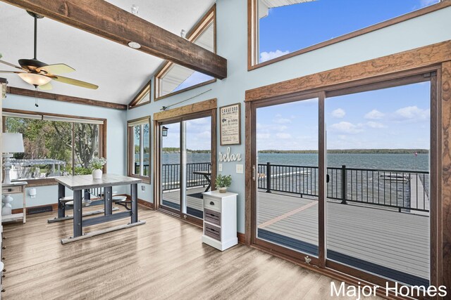 sunroom / solarium with a water view