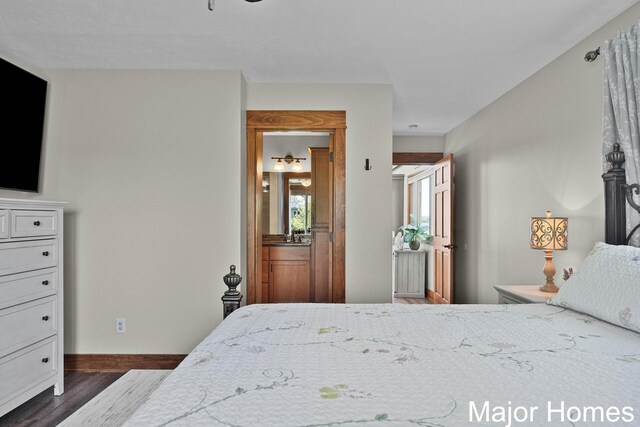 bedroom with dark wood-type flooring and baseboards