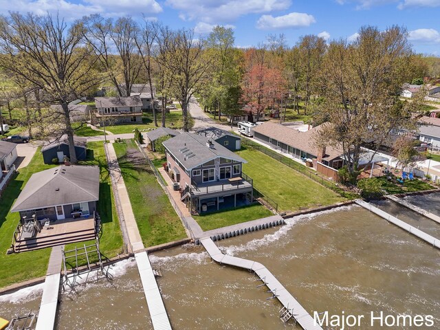 aerial view of residential area featuring a nearby body of water