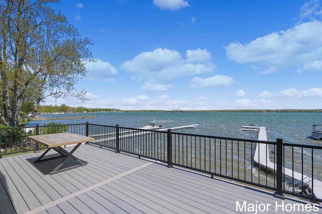wooden deck featuring a water view and a dock