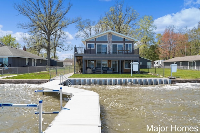rear view of property featuring a water view and a balcony