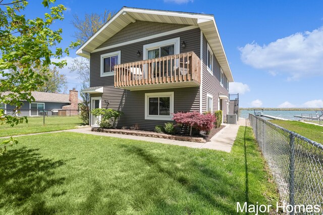 back of house featuring a balcony, central air condition unit, and a water view