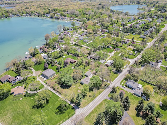 view of property location featuring a large body of water and nearby suburban area