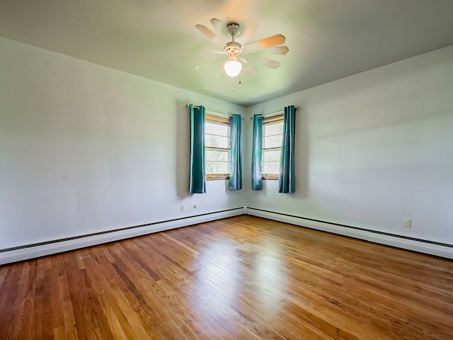 empty room with a ceiling fan and wood finished floors