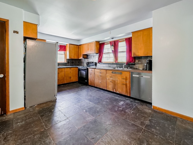 kitchen with stainless steel appliances, plenty of natural light, and backsplash