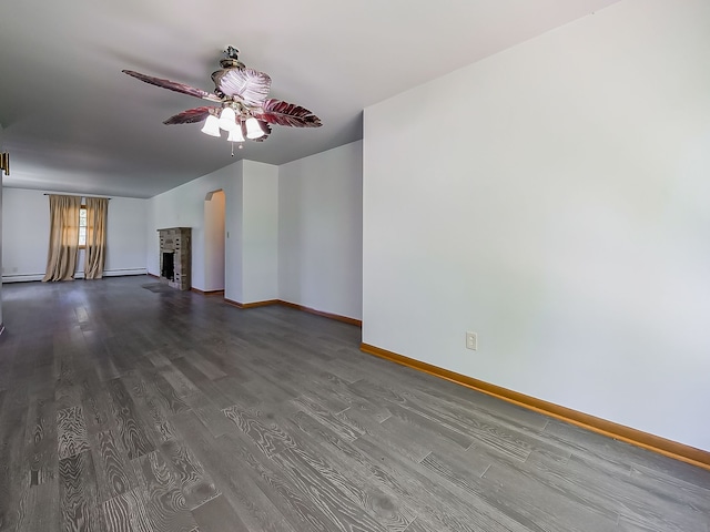 unfurnished living room with ceiling fan, dark wood-style floors, baseboards, arched walkways, and baseboard heating