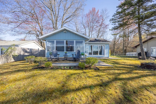 10401 N Chippewa Dr, Evart, MI 49631 - back of property with a sunroom and a deck