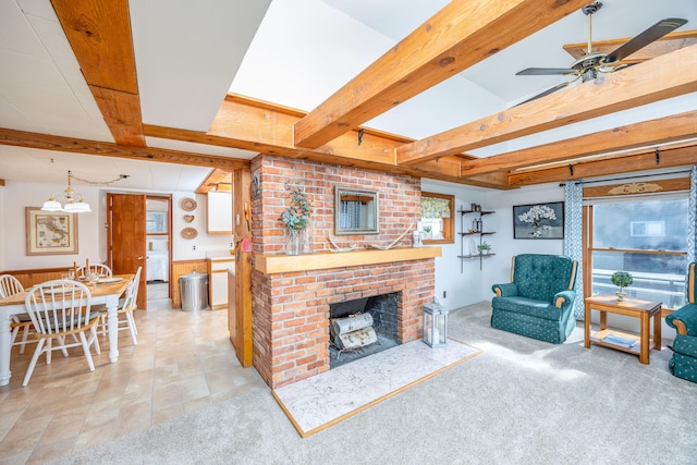 10401 N Chippewa Dr, Evart, MI 49631 - living room featuring beamed ceiling, ceiling fan, a fireplace, a chandelier, and a wainscoted wall