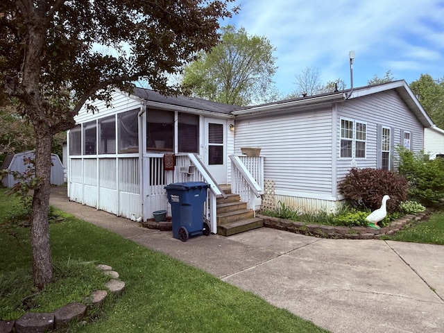 back of property with a sunroom