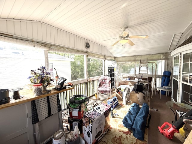 sunroom / solarium featuring vaulted ceiling, ceiling fan, and plenty of natural light