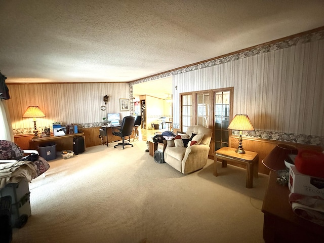 office space with carpet flooring, a textured ceiling, and wood walls