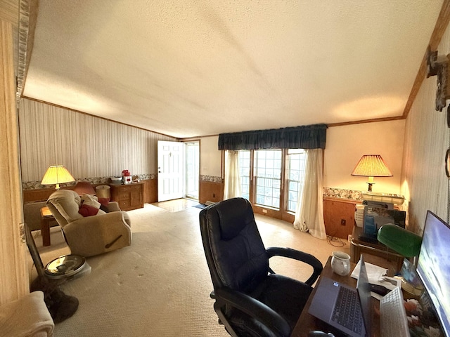 office with a textured ceiling, ornamental molding, light carpet, wainscoting, and wallpapered walls