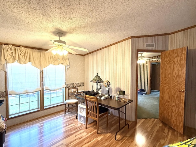 office area featuring crown molding, a textured ceiling, a ceiling fan, and wood finished floors