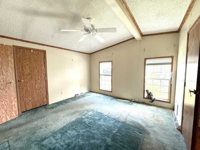 carpeted empty room featuring a textured ceiling, ceiling fan, and ornamental molding